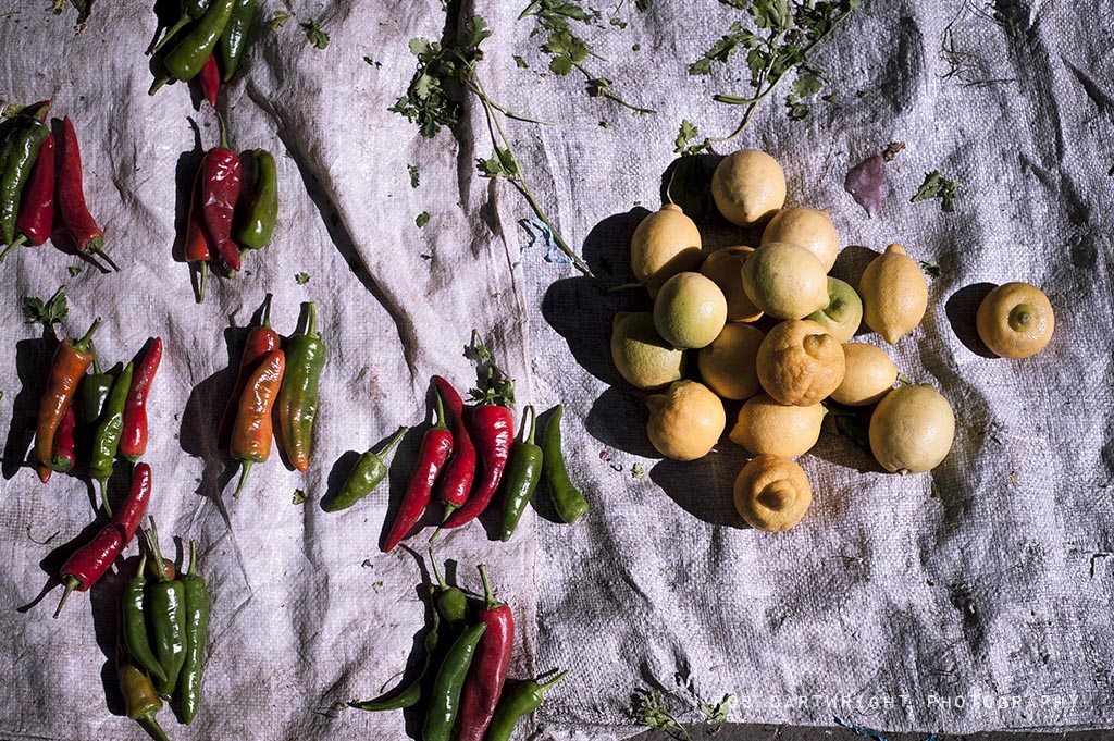 marrakesh maroc morocco north africa street urban market trade peppers chilis red green yellow lemons fresh food 50mm rob cartwright